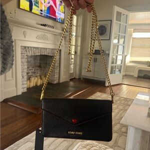 Miu Miu Black Clutch with Gold Chain and Red Accent